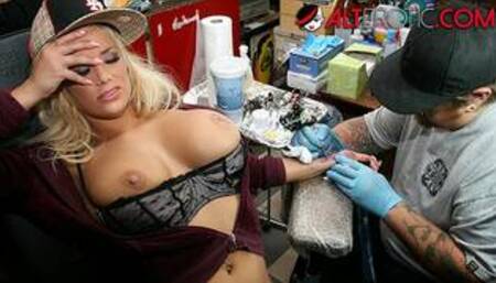 Shyla Stylez gets tattooed while playing with her tits