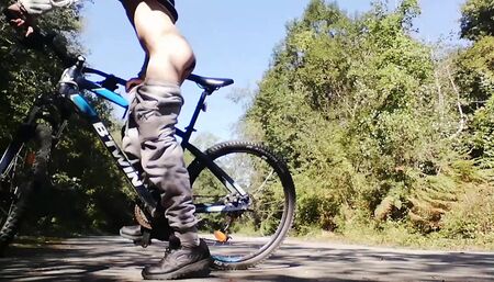 Slim boy with his bike in the park