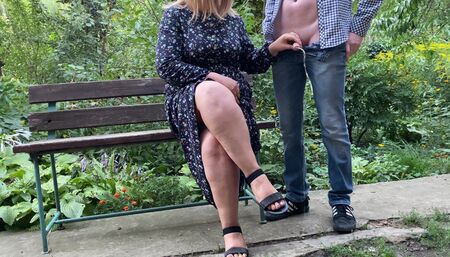 SHE holds his cock while HE pee in the park