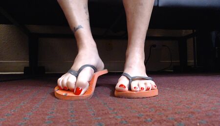 Red nails flip flop shoe play closeup