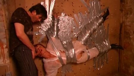 Dominus Ronaldo taped his redheaded slave to the wall and lets her suck him in that position