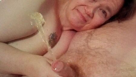 John is Pissing when Jen is giving him a Handjob on the Bed