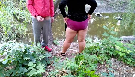 Curvy MILF with big ass masturbating jerking off big cock outdoors
