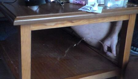 John is pissing on the table shelf