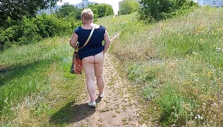 A fat woman walks through the park shows her ass and masturbates