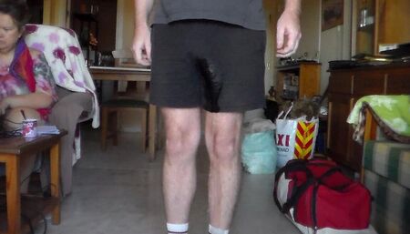 John is Peeing in his black shorts