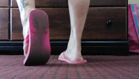 Worn out dirty pink flip flops