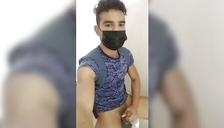 Young gay Latino in bathroom