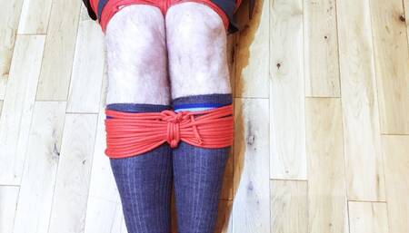 Man in adult school uniform bound and gagged on kitchen floor