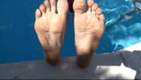 He films my feet and wrinkled soles while i'm chilling in a swimming pool