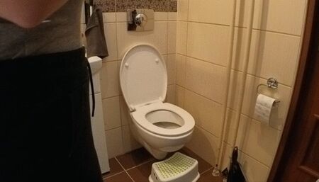 Sitting side on a toilet