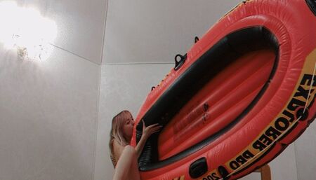 Alla inflates an orange inflatable boat with her mouth!!!