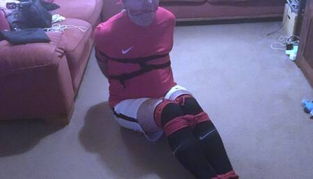 Footballer bound and gagged tight and squirming on floor