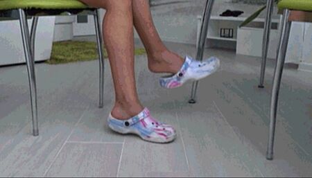 Dangling and toe tapping  in colored rubber slippers A?