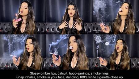 Ombre lips, pvc catsuit, hoop earrings, smoke rings, snap inhales, smoke in your face, long nails, dangling 100's white cigarette close up!