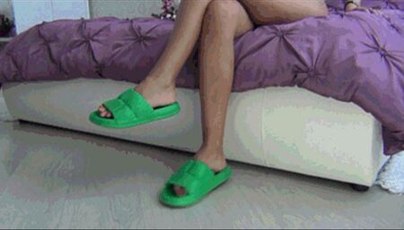 Dangling in green rubber flip flops a