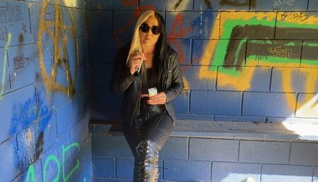 Leather outfit outside Virginia Slim 120 smoke