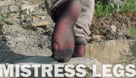 Jeans feet in black nylon socks on the seashore (MOV HD)