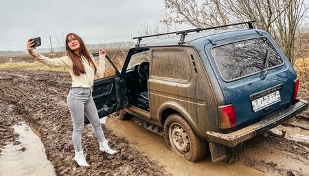 CAR STUCK Tanya enjoys being stuck in the mud at the Niva