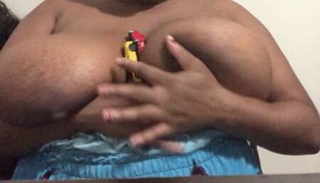 Giantess teasing teeny car with her huge breasts