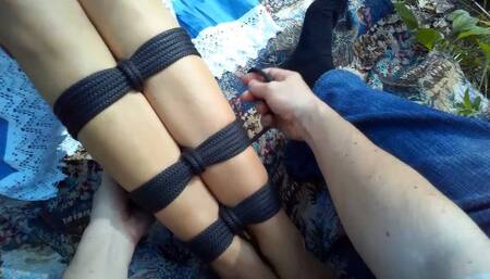 Sofi is in the park reading stories on her phone while her feet are tied_ POV