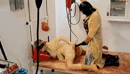 Kinky rubber girl with anal catheter get fucked with huge strap-on