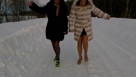 Two sexy girls on the slippery icy road on very high heel sandals