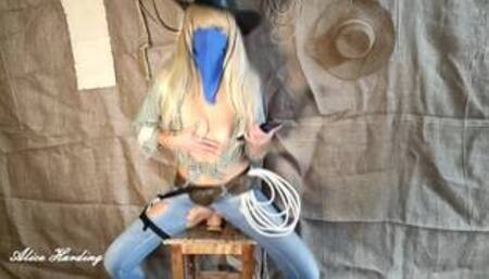 Alice dressed as a cowboy pulls a dildo out of her holster and masturbates in different positions