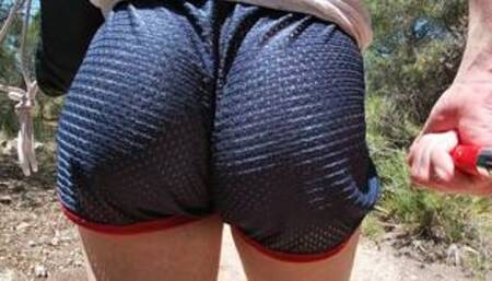 Hairy girl flashing her round ass in short shorts