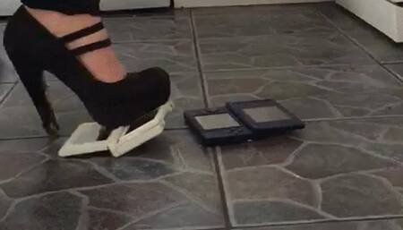 2 nintendo's games consoles crushed under 2 metal tip heels