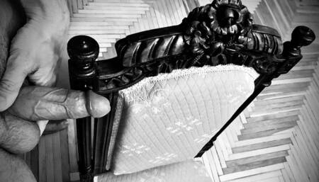 Guy jerks off on a vintage chair and cums on himself at the end