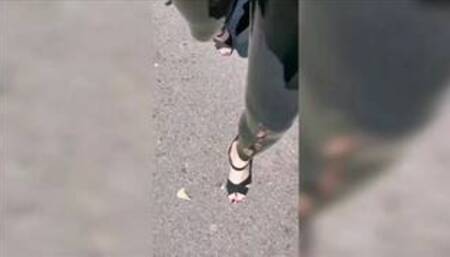 Girl wearing latex leggings and high heels in public