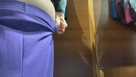 Curvy MILF in the mall fitting room trying on skirts.