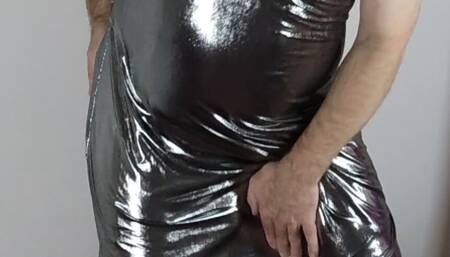 Crossdresser in a full-length metallic shiny silver ballgown