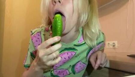 The cutie is playing with a cucumber. Completely thrusts a cucumber into her pussy and mouth