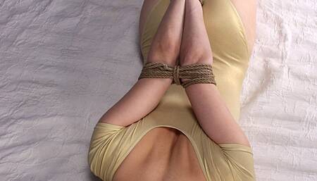 Anne: barefoot girl in yellow leotard, hogtied with her elbows tightly bound together, rolls over the bed (HD MP4)