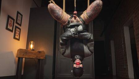 Inverted Straitjacket Suspension - Heavy and Elise Graves - Elise straps Heavy into a sexy leather SJ, ballet boots and hood before suspending them upside down with an intense ball tie!