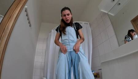 Desperate peeing in jeans overalls