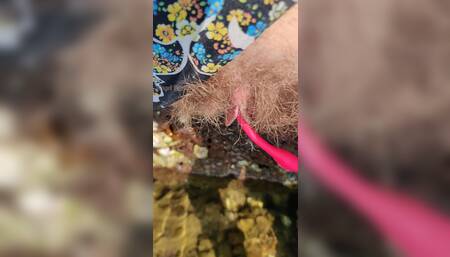 Hairy pussy with Lovense pissing in water