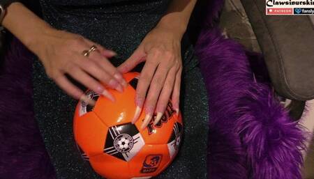 Nails scratching the soccer ball hard and finally puncture