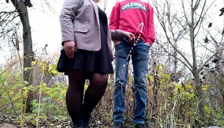 Mother-in-law in a short dress holds son-in-law's cock and excites him