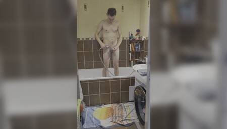 Amateur young man showering himself