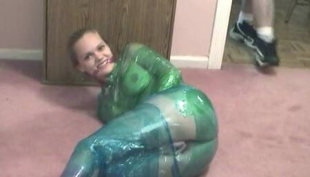 Fetish chick loves being wrapped in green plastic with her shaved pussy