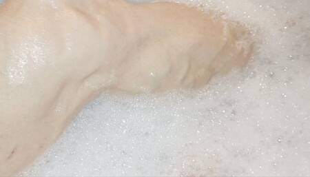 Taking a bubble bath and flexing
