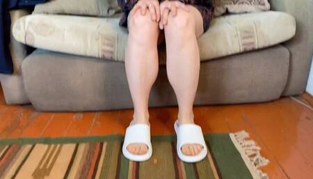 bare feet in white slippers