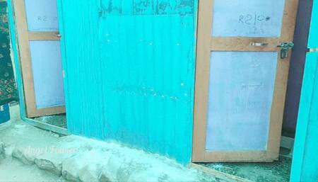 White tourist pisses in an Indian style outdoor toilet