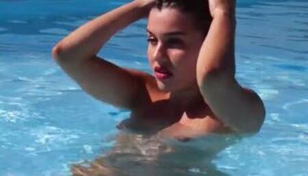 Naked French beauty posing by the pool