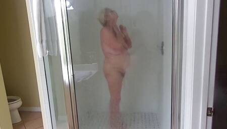 Sexy mature blonde granny takes a shower as we stepdaughter films