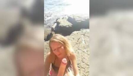 Hot blonde gives blowjob on the beach