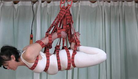 MILF in a sexy catsuit for a belt suspension